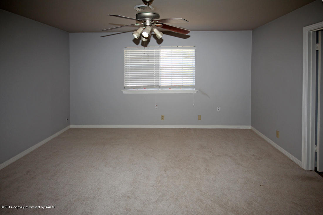7203 Elmhurst Road Amarillo, TX 79106 - Photo 16 of 30 an empty room with a window and a fan
