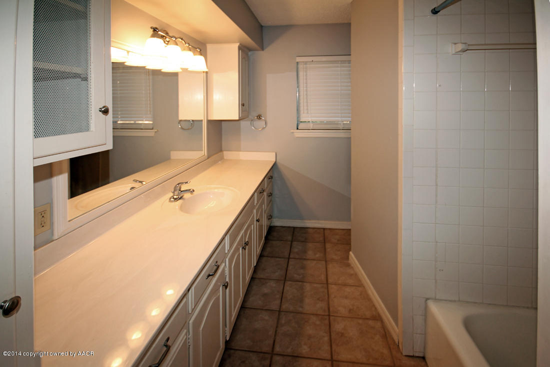 7203 Elmhurst Road Amarillo, TX 79106 - Photo 24 of 30 a bathroom with a sink and a mirror