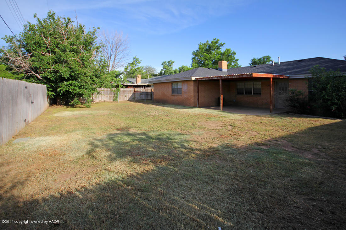 7203 Elmhurst Road Amarillo, TX 79106 - Photo 30 of 30 a front view of a house with a yard and potted plants