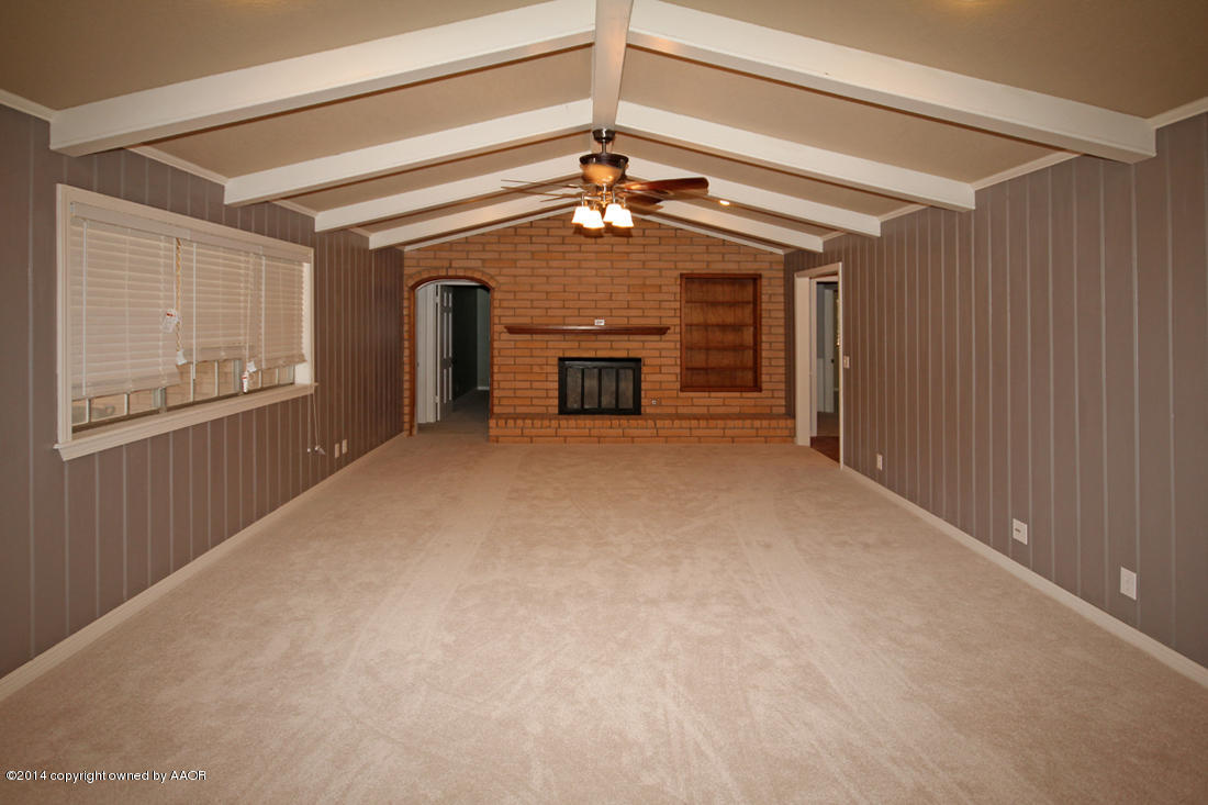 7203 Elmhurst Road Amarillo, TX 79106 - Photo 7 of 30 a view of a livingroom with a ceiling fan and window