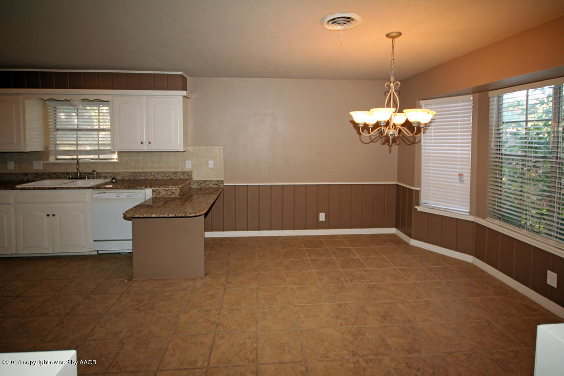 7203 Elmhurst Road Amarillo, TX 79106 - Photo 8 of 30 a view of a room with appliances and chandelier