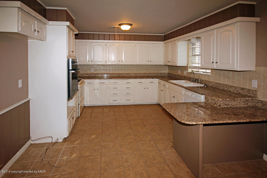 7203 Elmhurst Road Amarillo, TX 79106 - Photo 10 of 30 a kitchen with a sink and cabinets