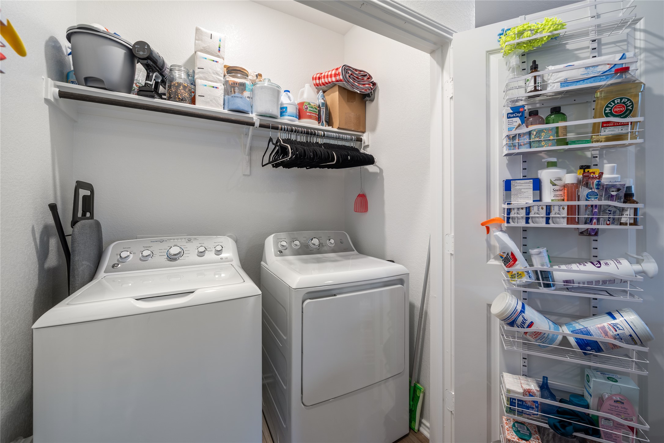 14404 Berning Road Manor, TX 78653 - Photo 24 of 38 Functional laundry room includes ample storage space with a built-in shelf and hanging rod.