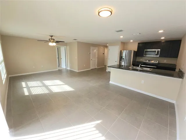 a view of a kitchen with a sink and a window