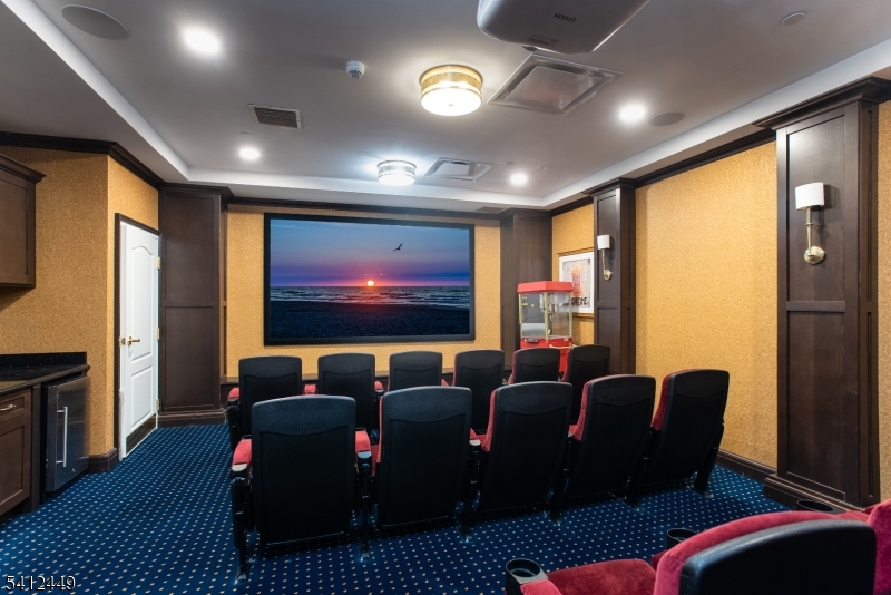 41 Springfield Avenue Summit, NJ 07901 - Photo 12 of 19 a media room with lots of chairs and a projector screen