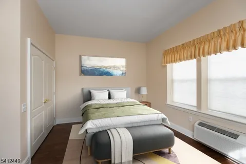 a bedroom with a bed and a large window