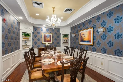 a view of a dining room with furniture and chandelier