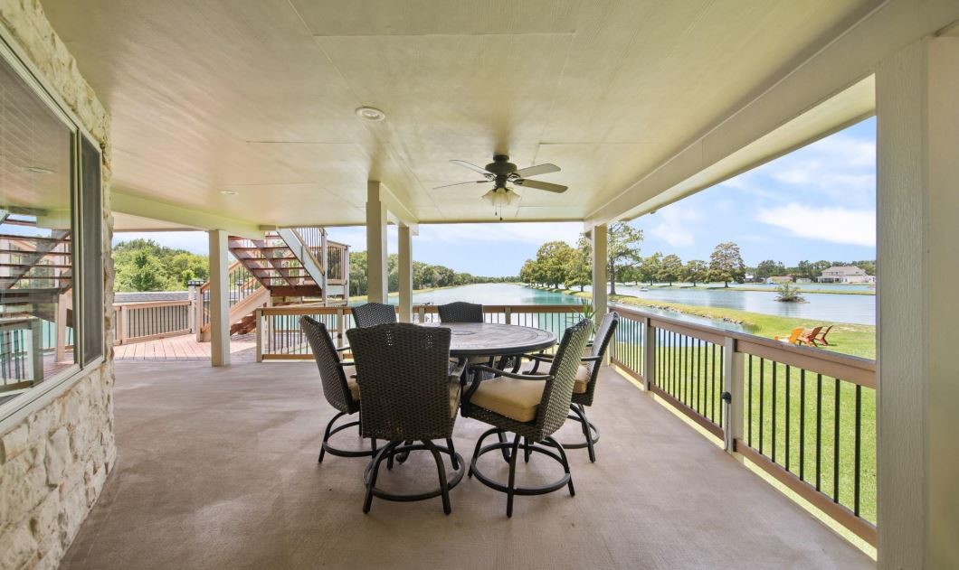 6714 Spray Lane, Unit C699A Rosharon, TX 77583 - Photo 23 of 48 2nd Floor Covered Deck just off the Sunroom. Ceiling Fan for a Breeze & Shady Lounging Spot to Enjoy the Beautiful Blue LAKES.