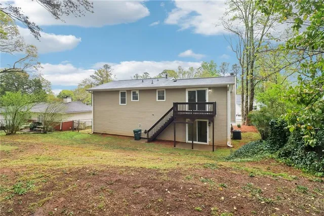 a view of a house with a yard and garage