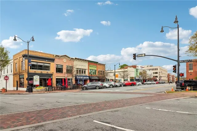 a swimming pool view with a seating space and a garden