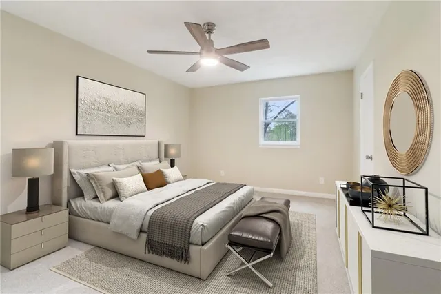 a bedroom with bed a mirror and a flat screen tv