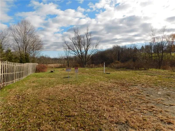 a view of a field with an trees