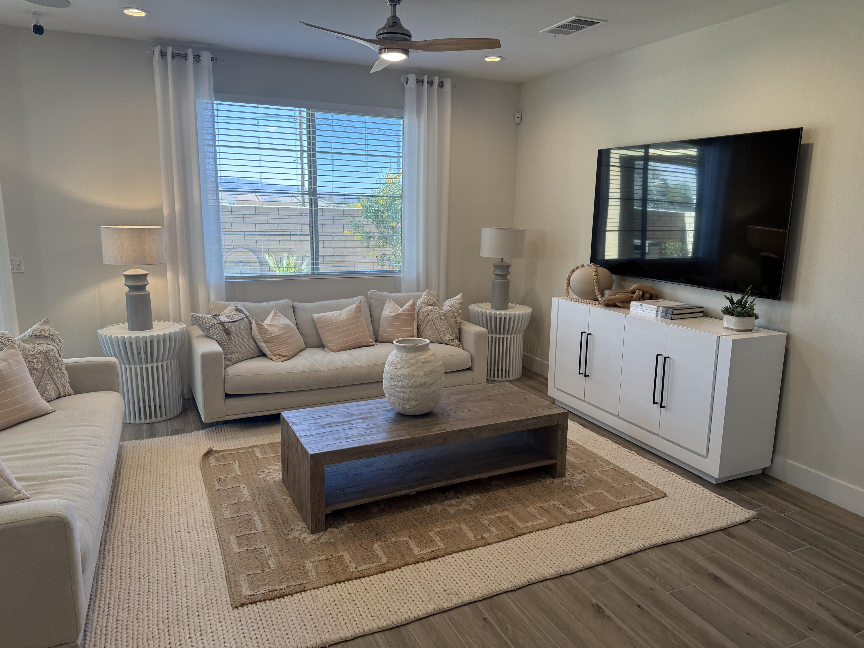 39912 Felicita Parkway Palm Desert, CA 92211 - Photo 2 of 32 a living room with furniture and a flat screen tv