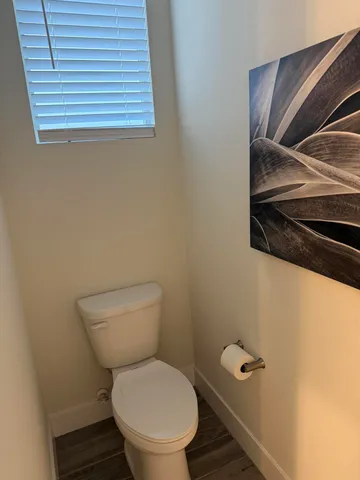 a toilet sitting in a bathroom next to a sink