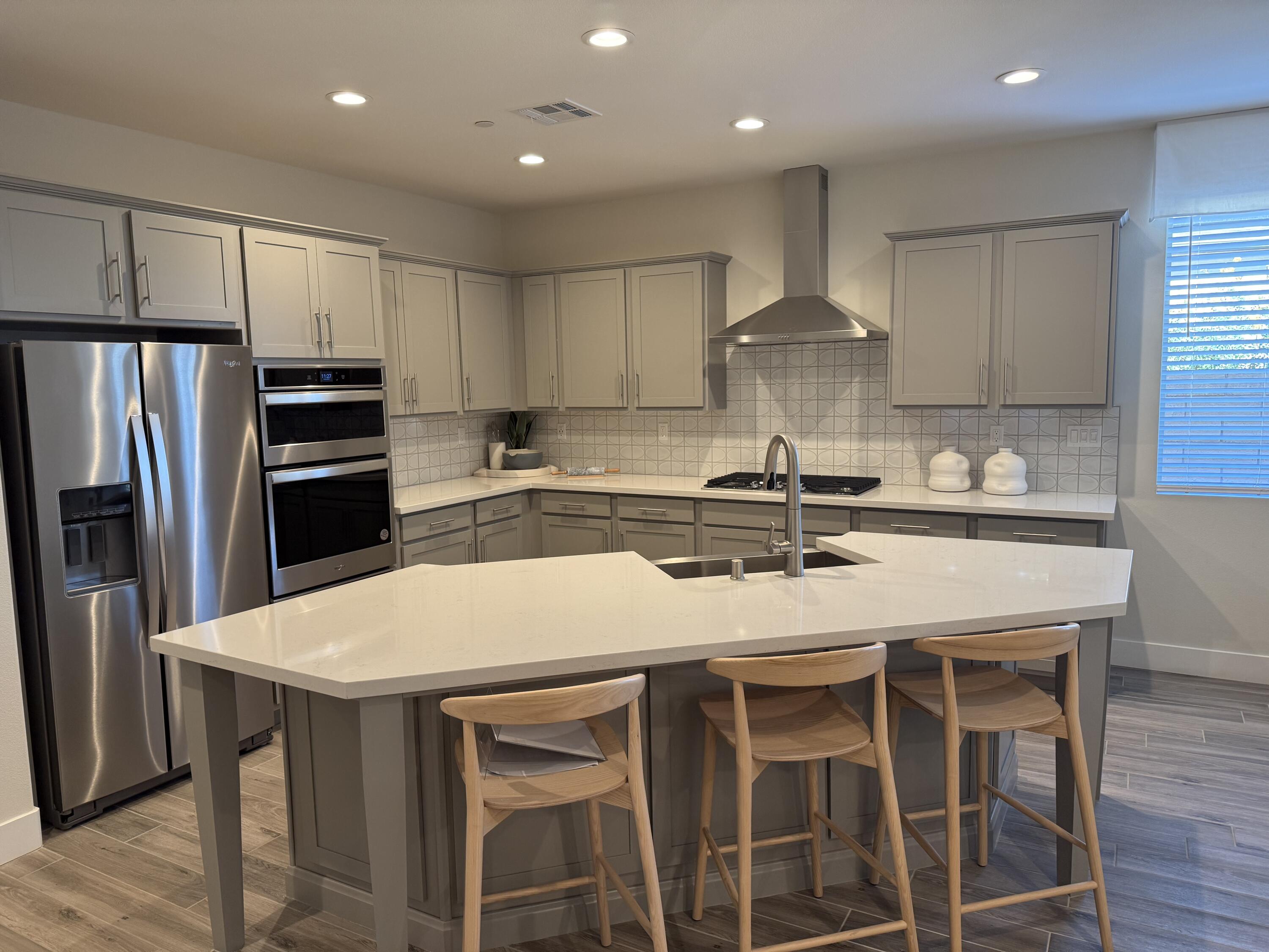 39912 Felicita Parkway Palm Desert, CA 92211 - Photo 4 of 32 a kitchen with kitchen island granite countertop a sink and stainless steel appliances