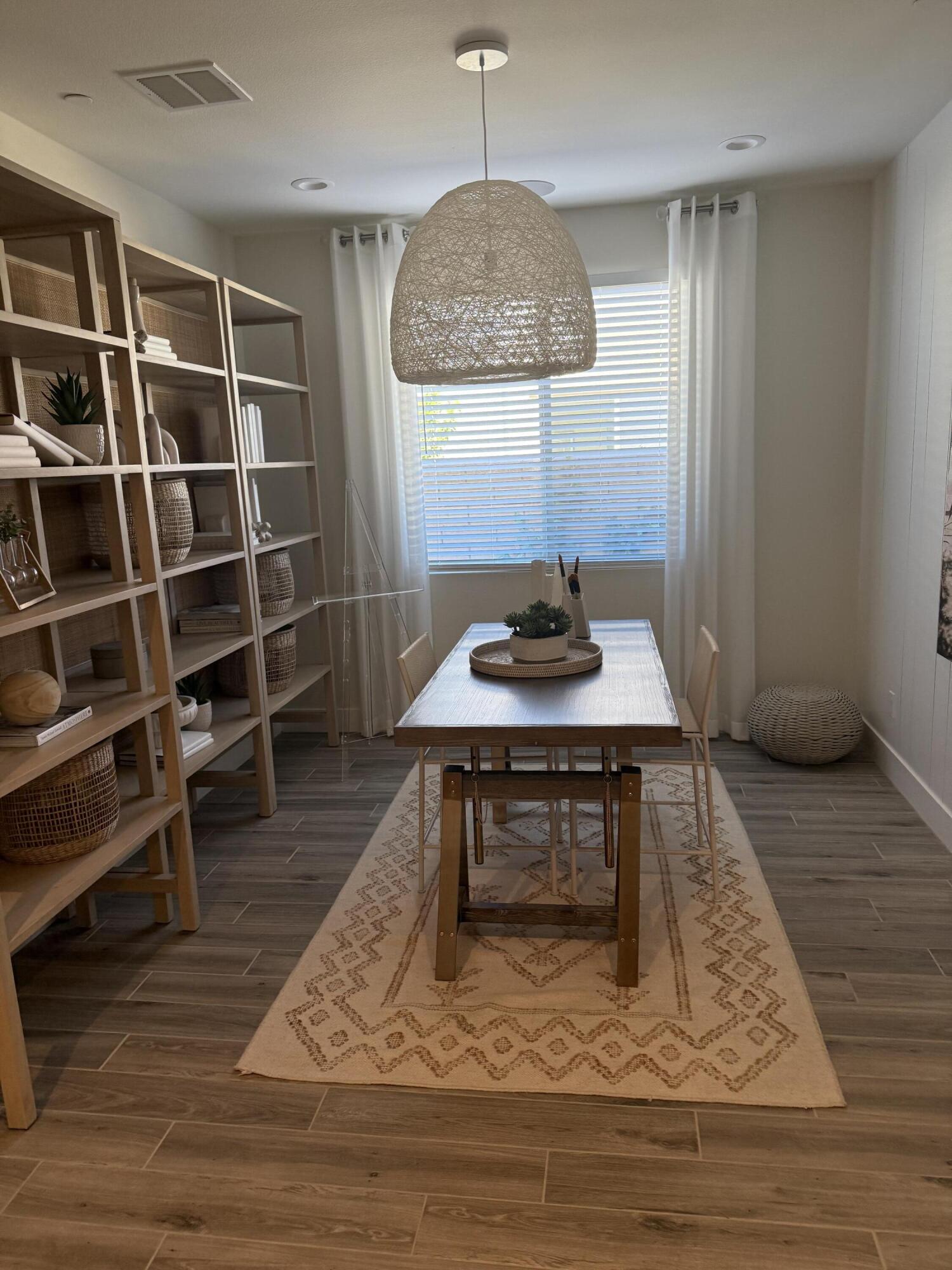 39912 Felicita Parkway Palm Desert, CA 92211 - Photo 10 of 32 a living room with wooden floor and a book shelf