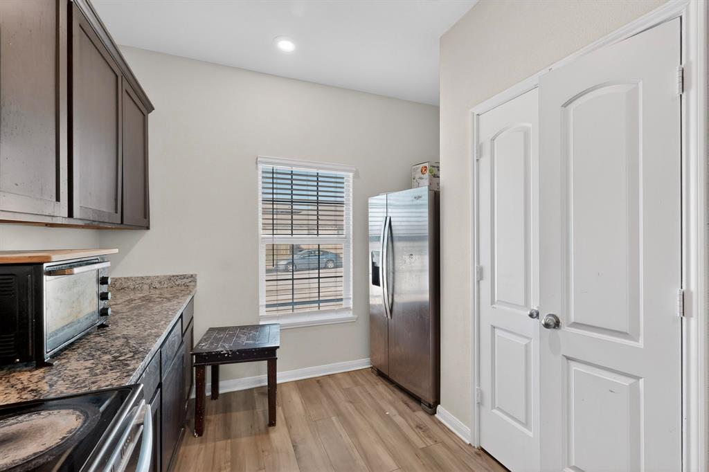 148 Point Rider Road Newark, TX 76071 - Photo 13 of 40 Kitchen featuring stainless steel appliances and light wood finished floors