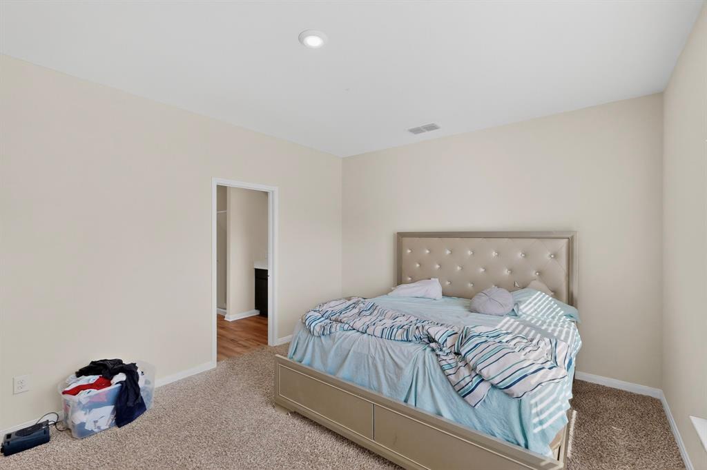 148 Point Rider Road Newark, TX 76071 - Photo 20 of 40 Carpeted bedroom with baseboards