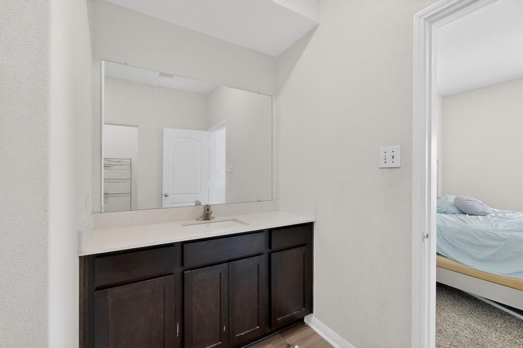 148 Point Rider Road Newark, TX 76071 - Photo 21 of 40 Ensuite bathroom featuring vanity and baseboards