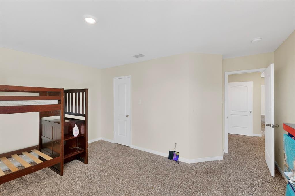 148 Point Rider Road Newark, TX 76071 - Photo 25 of 40 Bedroom featuring carpet and baseboards