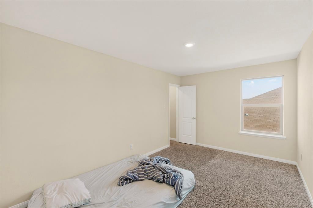 148 Point Rider Road Newark, TX 76071 - Photo 31 of 40 Unfurnished bedroom featuring baseboards and carpet flooring