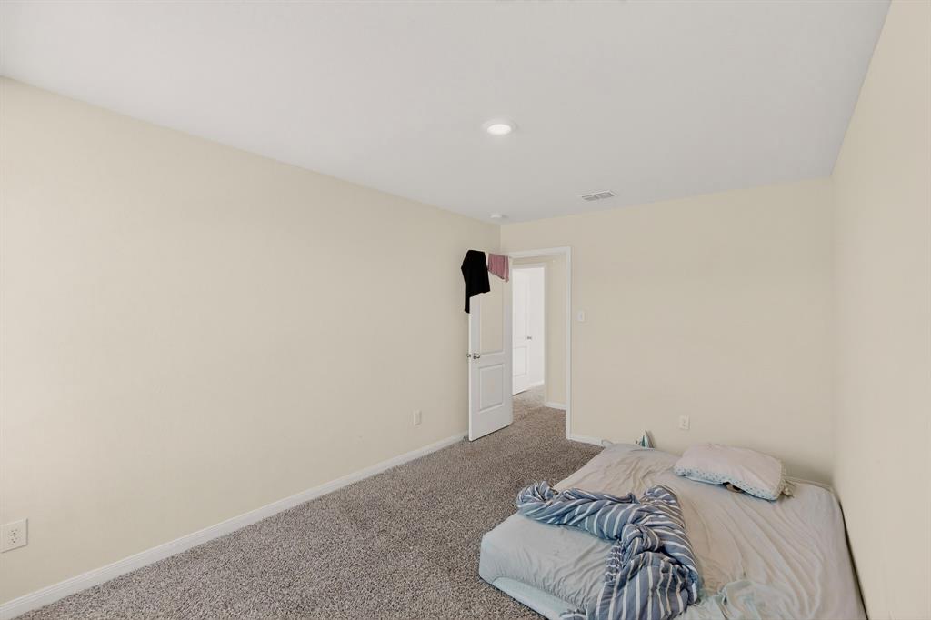 148 Point Rider Road Newark, TX 76071 - Photo 32 of 40 Unfurnished bedroom featuring carpet floors and baseboards