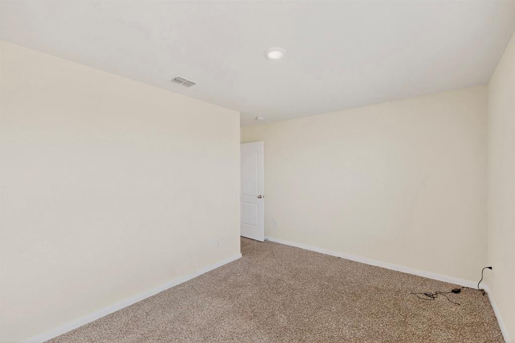 148 Point Rider Road Newark, TX 76071 - Photo 34 of 40 Carpeted spare room featuring baseboards