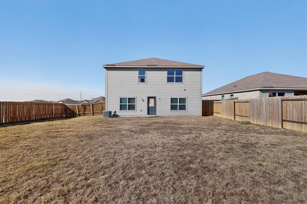 148 Point Rider Road Newark, TX 76071 - Photo 36 of 40 Rear view of house with a fenced backyard