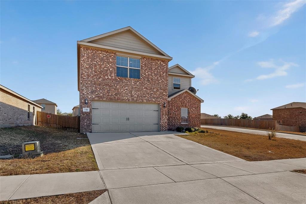 148 Point Rider Road Newark, TX 76071 - Photo 4 of 40 Traditional home featuring brick siding, driveway, and an attached garage