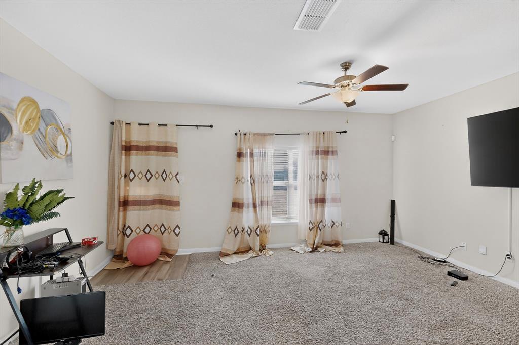 148 Point Rider Road Newark, TX 76071 - Photo 7 of 40 Exercise room with carpet and a ceiling fan