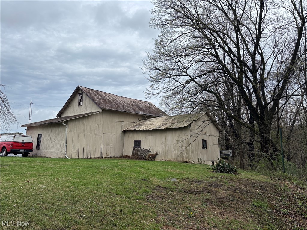 6380 Old River Road Philo, OH 43771 - Photo 4 of 26 View of side of property featuring a lawn, an outbuilding, and a pole building