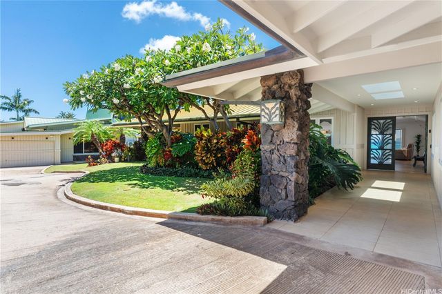 a view of a hallway with potted plants
