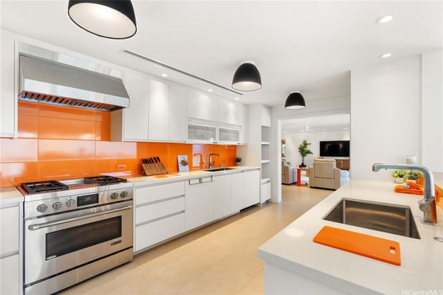 a view of kitchen with stainless steel appliances granite countertop a sink and a stove