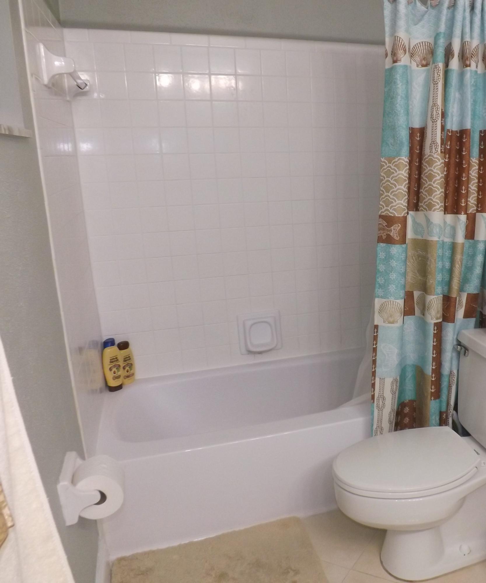 64 Davis Road Palm Springs, FL 33461 - Photo 15 of 32 a bathroom with a shower and a toilet