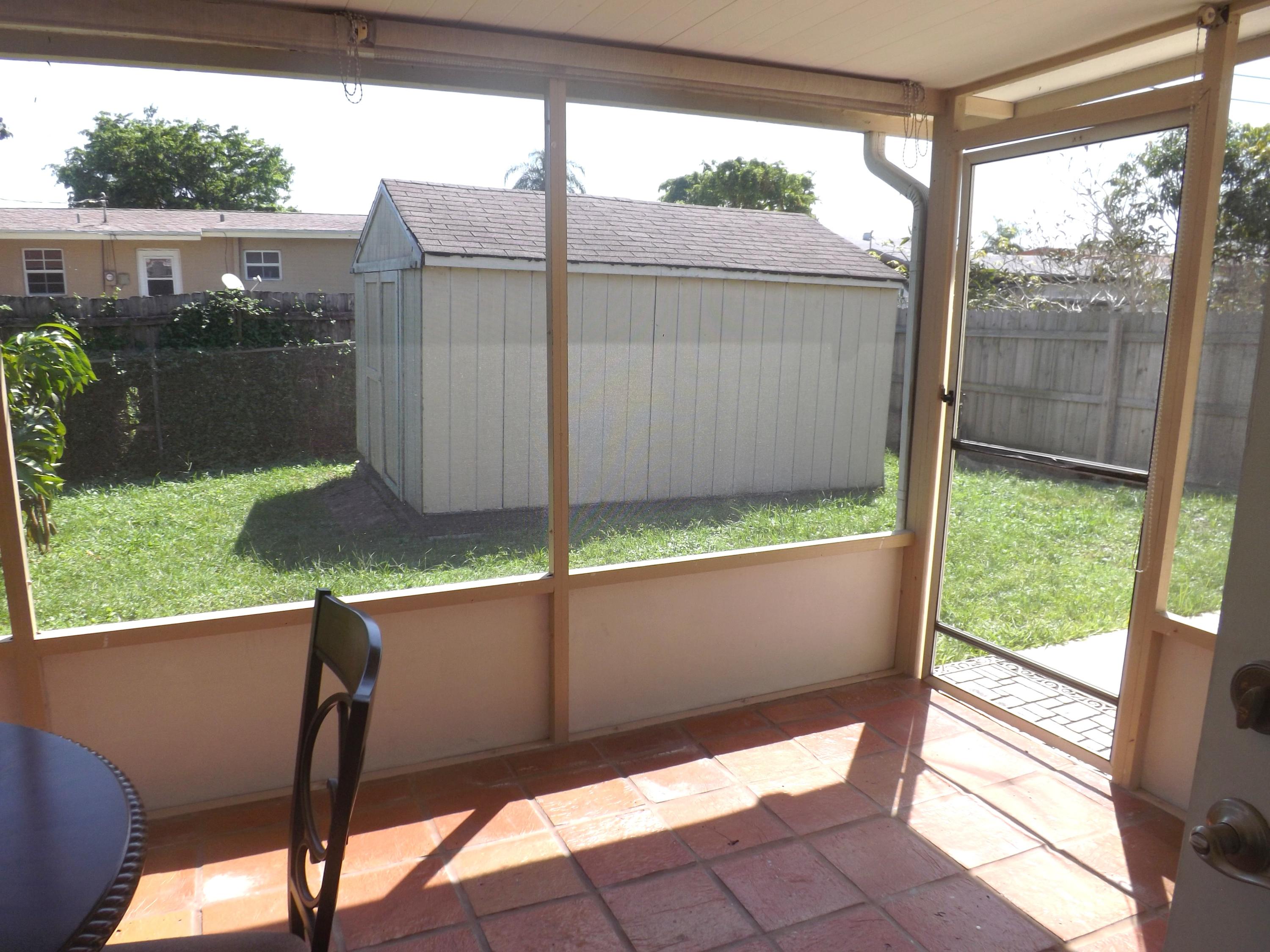 64 Davis Road Palm Springs, FL 33461 - Photo 28 of 32 a view of balcony with yard