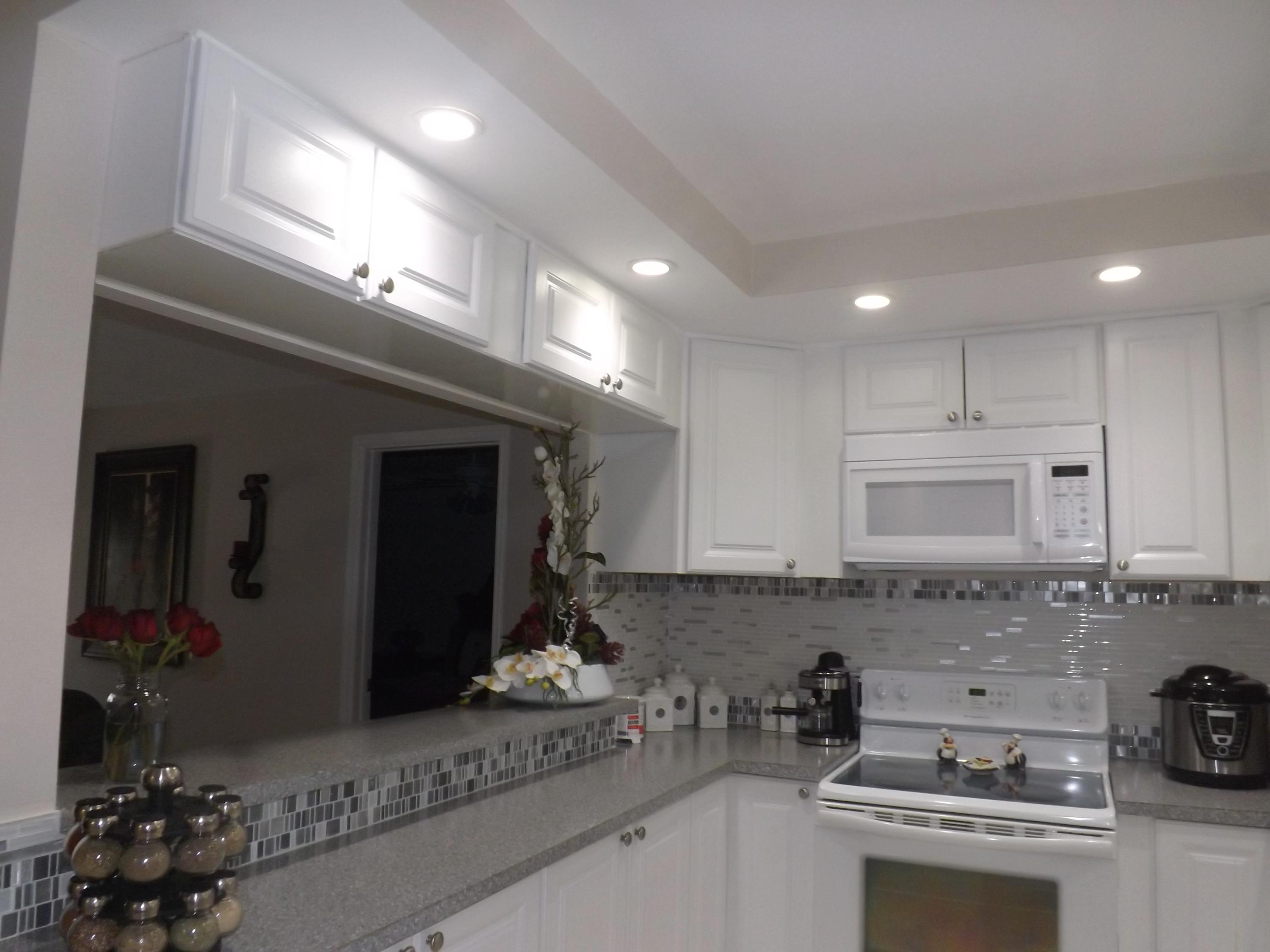64 Davis Road Palm Springs, FL 33461 - Photo 6 of 32 a kitchen with a sink and cabinets