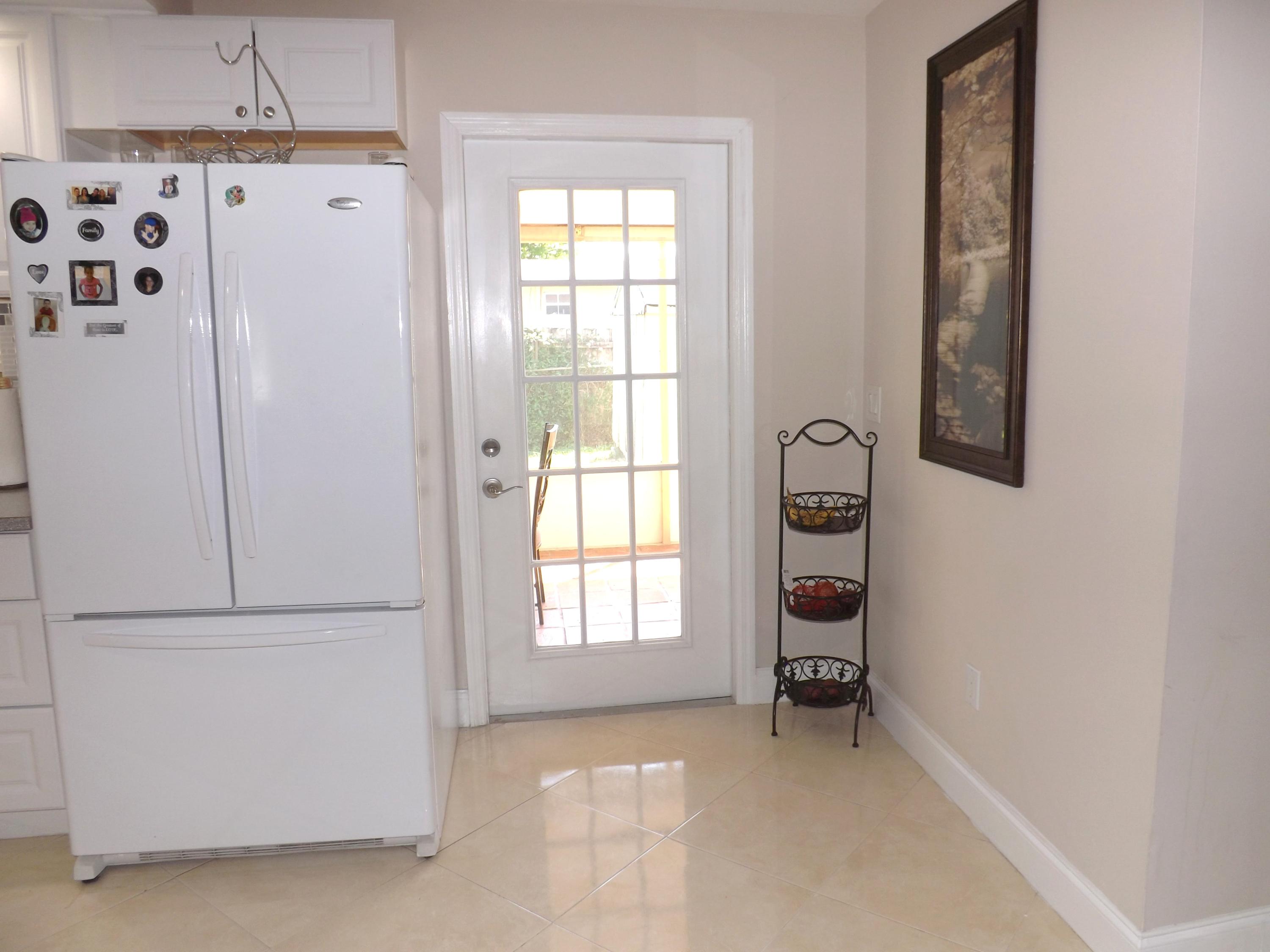64 Davis Road Palm Springs, FL 33461 - Photo 10 of 32 a view of an empty room with window and cabinet