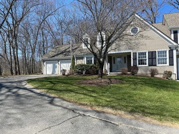 a large kitchen with stainless steel appliances granite countertop a refrigerator a sink dishwasher a dining table and chairs with wooden floor