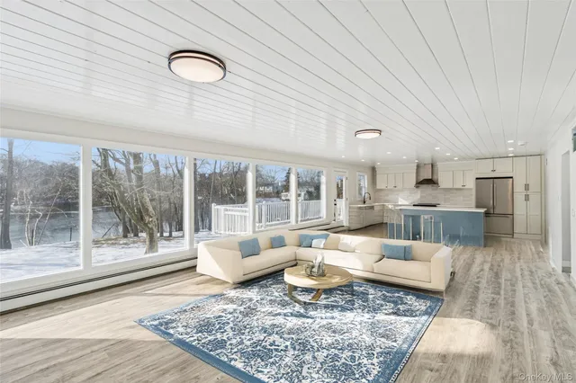 a large white kitchen with a large window