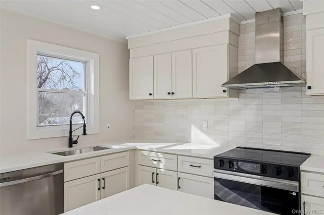 a view of a livingroom with wooden floor and a potted plant
