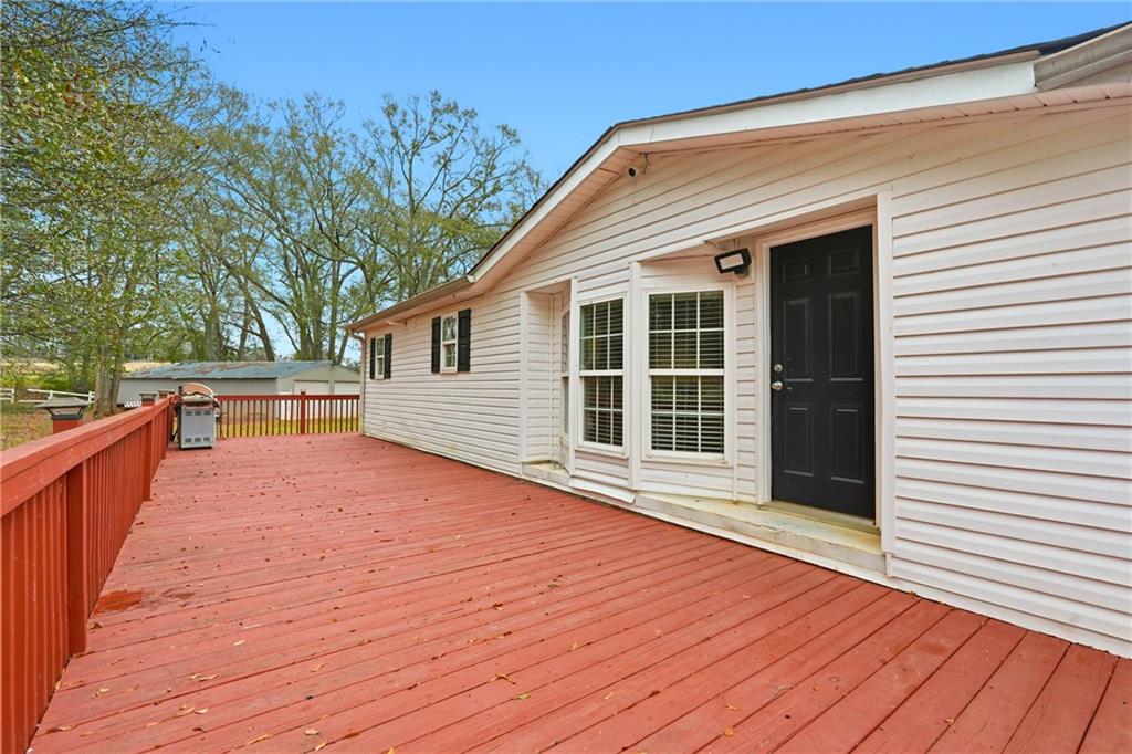 1295 Double Bridges Road Winder, GA 30680 - Photo 7 of 57 a view of a house with a wooden deck