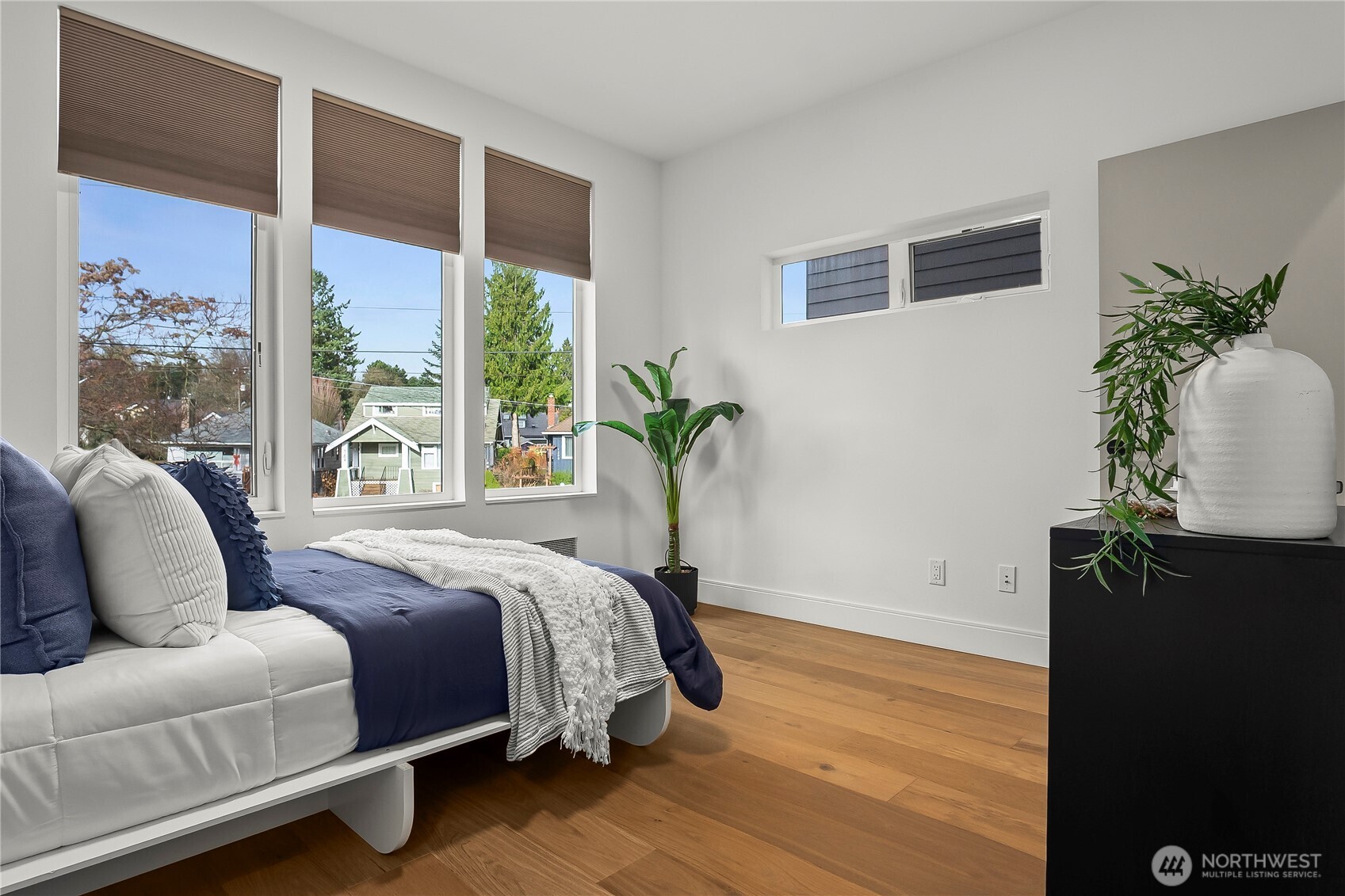 4758 Green Lake Way North Seattle, WA 98103 - Photo 13 of 26 a bedroom with a large bed and a potted plant