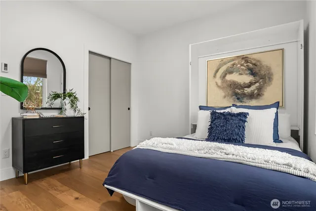 a bedroom with a bed and a dresser