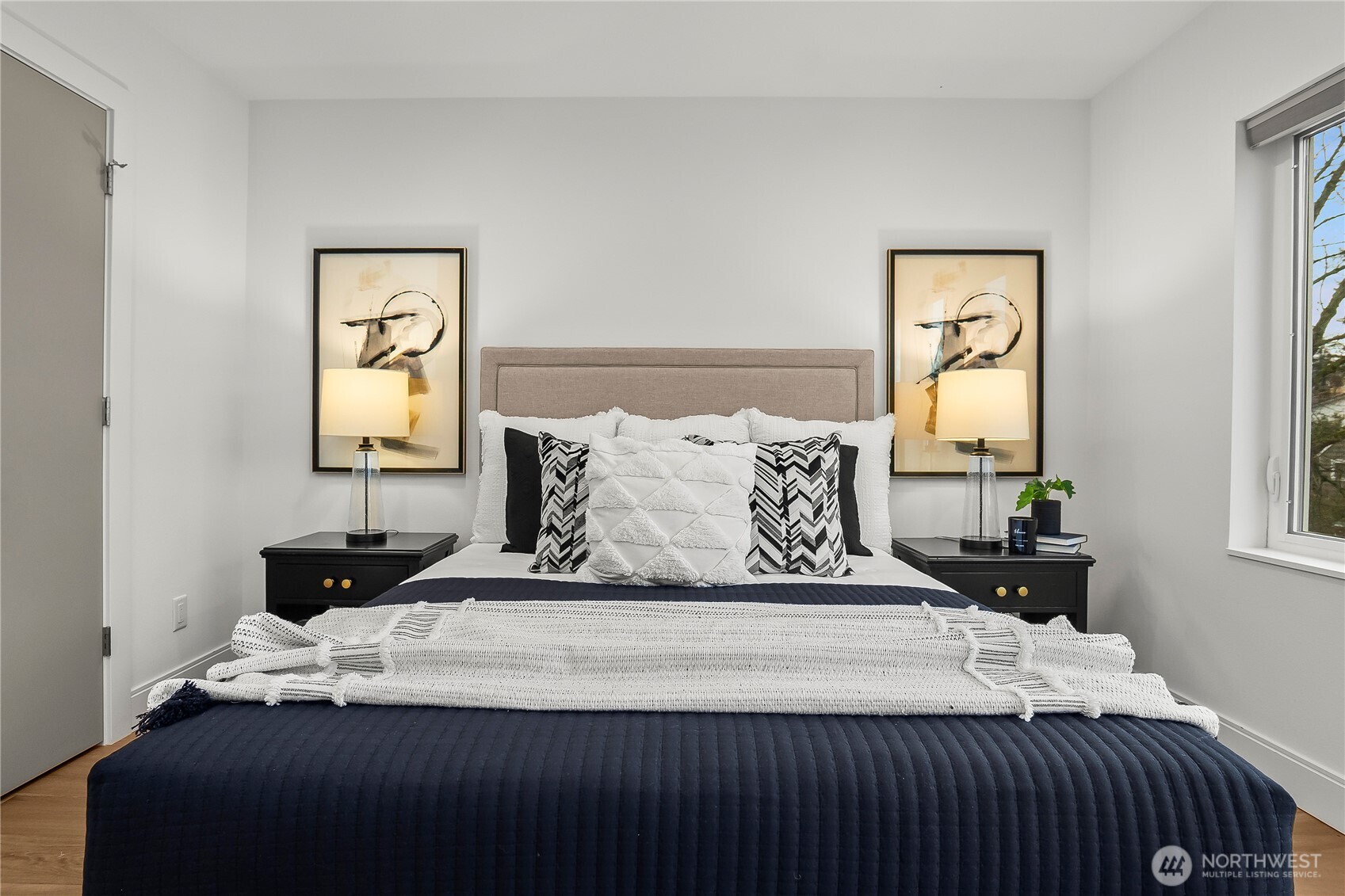 4758 Green Lake Way North Seattle, WA 98103 - Photo 17 of 26 a bedroom with a bed and wooden floor