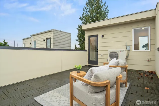 a backyard of a house with table and chairs