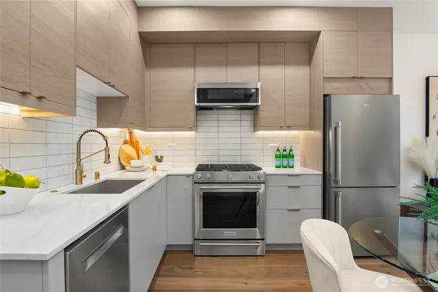 a kitchen with a sink appliances and cabinets