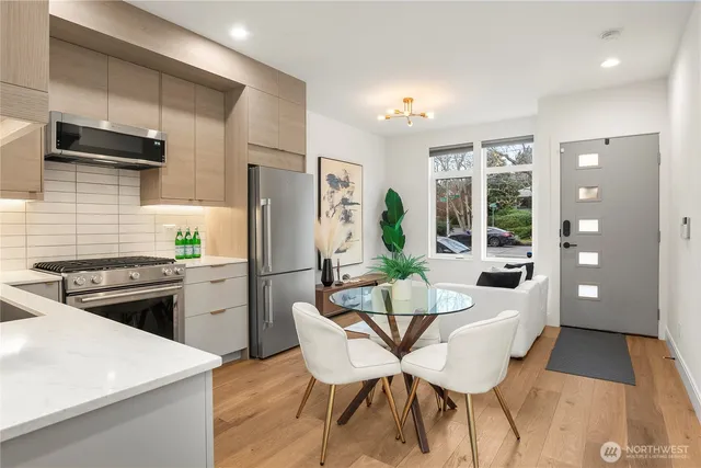 a kitchen with stainless steel appliances kitchen island granite countertop a refrigerator and a stove top oven