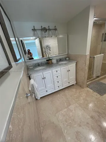 a spacious bedroom with two beds and chair