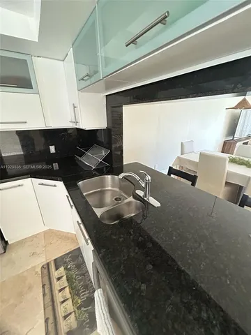 a kitchen with a sink and cabinets