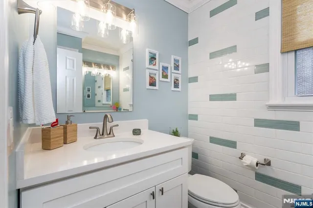 a bathroom with a sink a toilet and mirror